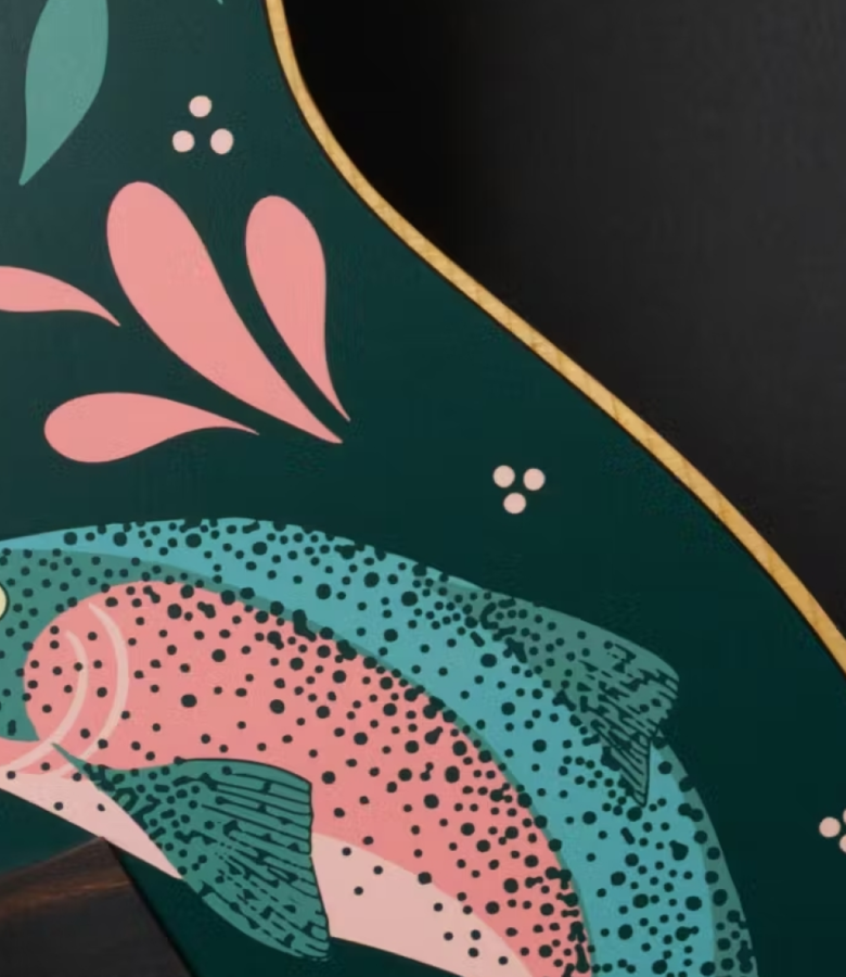 Hero closeup of a stio x taylor guitars guitar featuring a pink and green fish
